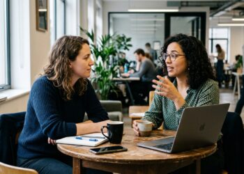 Two people in a focused, candid one-on-one conversation reading each others emotional cues