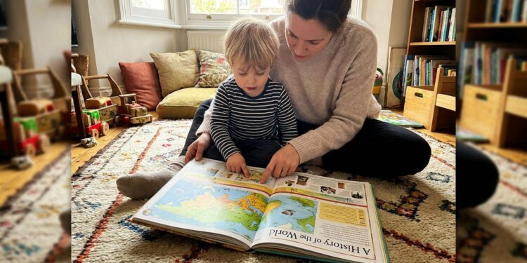 Parent and child reading an illustrated history book together on a rug